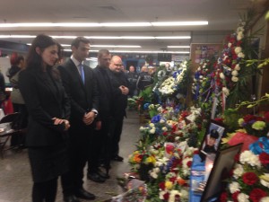 Vlora Citaku, Kosovo Ambassador to USA, consul and staff place flowers at the pic of the two killed cops